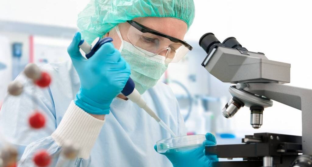 Scientist with dropper working at the laboratory Scientist with dropper working at the laboratory